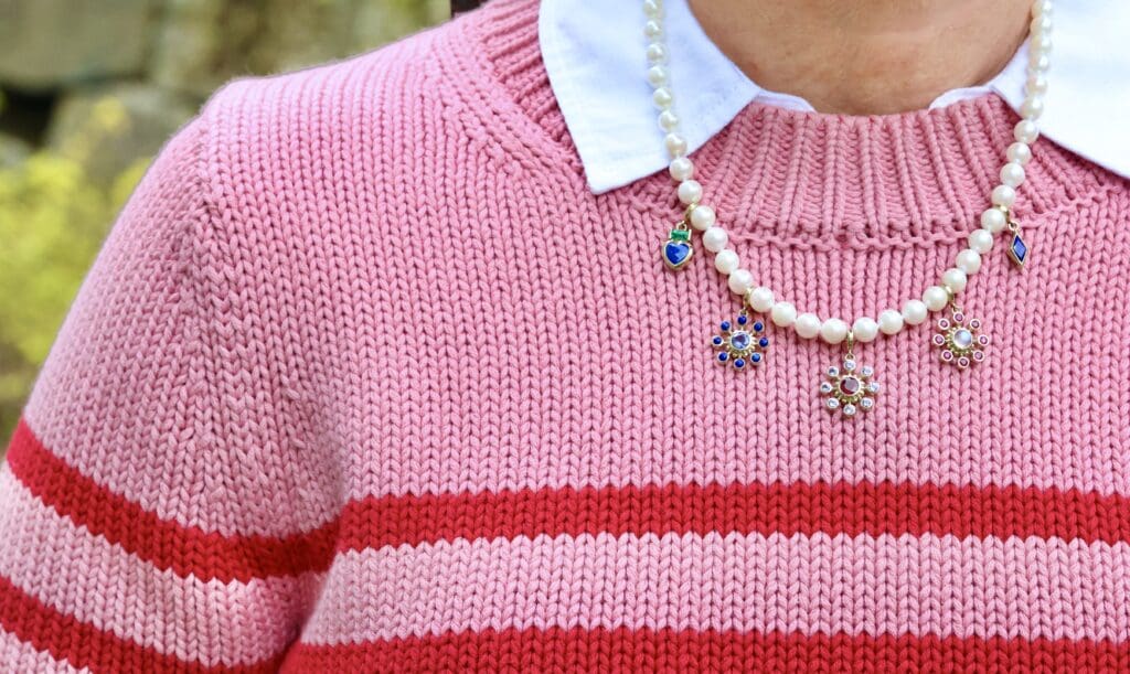 The Akoya pearl strand with the Tillya Tepe Heart Charm, Lapis and Sapphire Cosmos Charm, Tanzanite and Ruby Cosmos Charm, Ruby and Moonstone Cosmos Charm, and Zan Charm in Lapis Lazuli. Photo by Chloe Beaumont