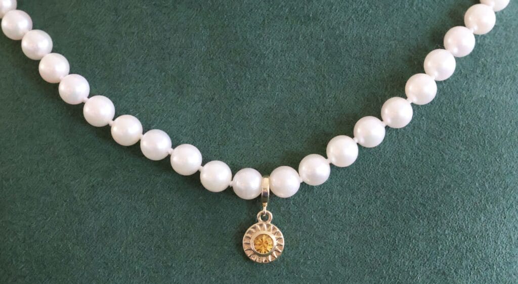 The Akoya Pearl Necklace with the Sunburst Charm added in the center. Photo by Chloe Beaumont